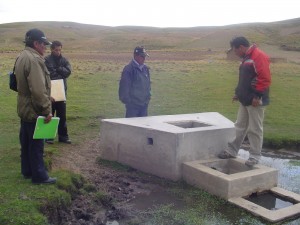 Our staff and Jankoaqui villagers examining a previous water installation.